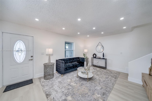 living room featuring light hardwood / wood-style floors and a textured ceiling