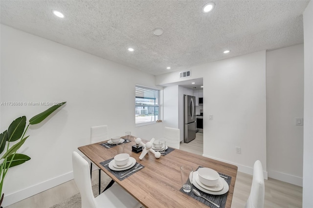 office featuring light hardwood / wood-style floors and a textured ceiling