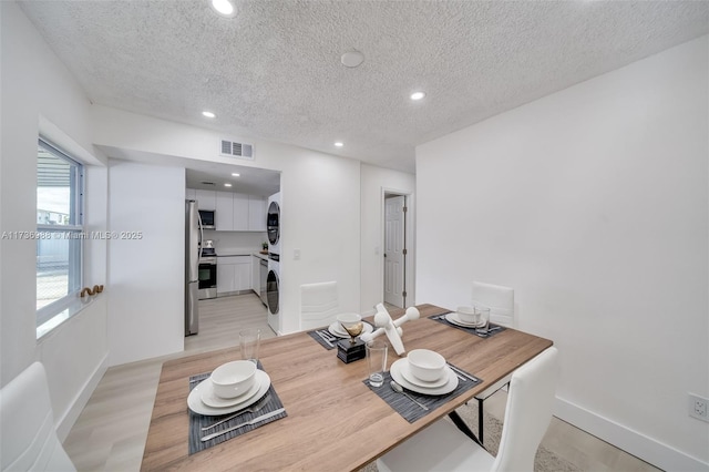 home office featuring a textured ceiling and light hardwood / wood-style floors