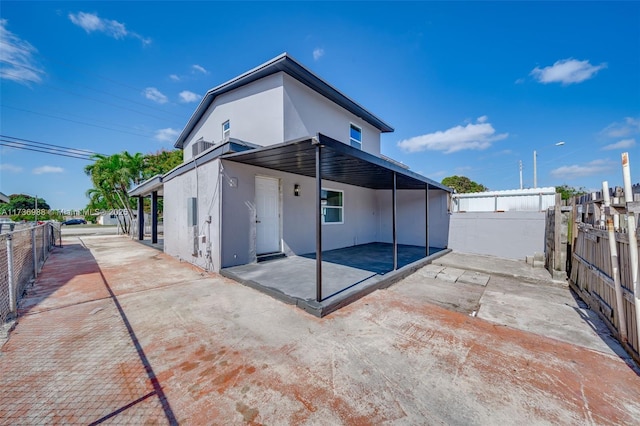 back of property featuring a patio area