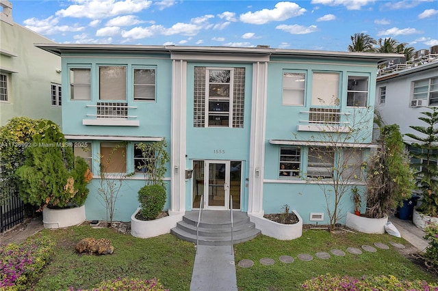 view of front of property with a front yard and french doors