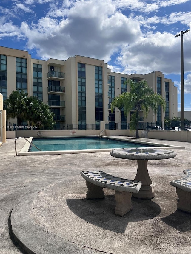 view of swimming pool with a patio area