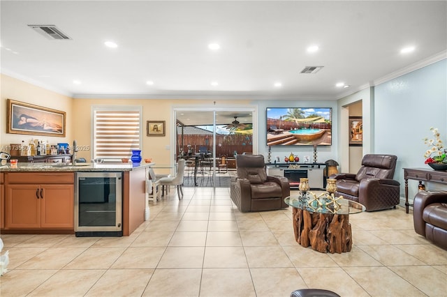 tiled living room featuring crown molding, indoor wet bar, beverage cooler, and ceiling fan