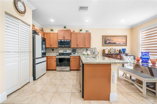 kitchen with sink, ornamental molding, stainless steel appliances, and light stone countertops