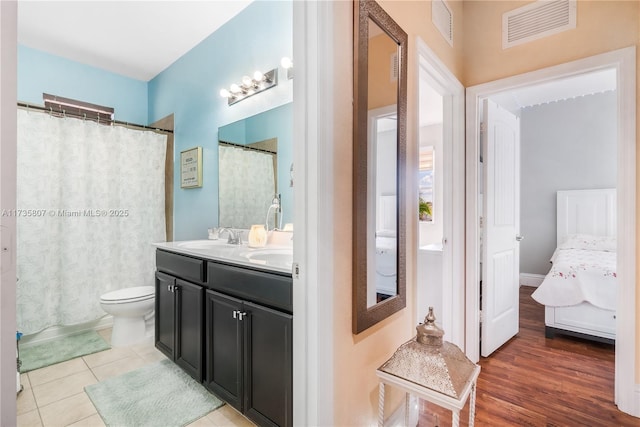 bathroom with vanity, toilet, and tile patterned flooring