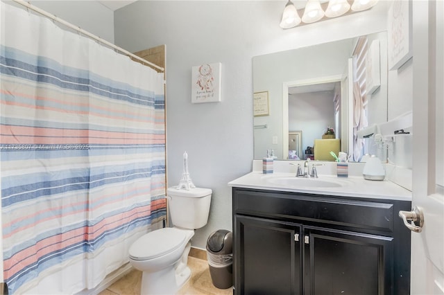 bathroom with tile patterned flooring, vanity, and toilet