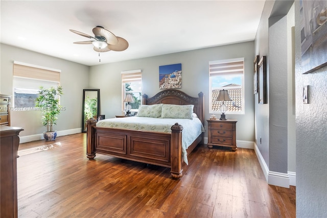 bedroom with multiple windows, dark wood-type flooring, and ceiling fan