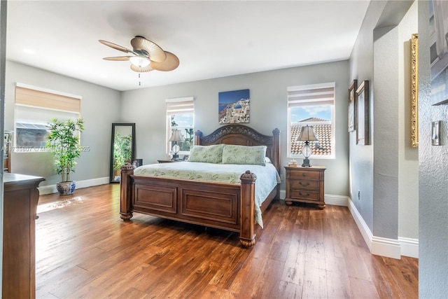 bedroom with dark hardwood / wood-style floors and ceiling fan