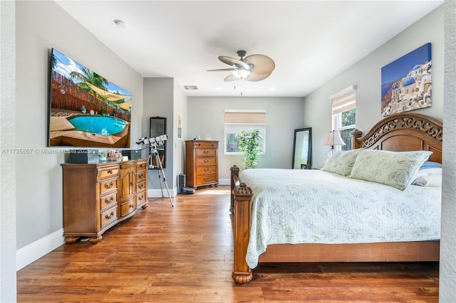 bedroom with hardwood / wood-style flooring and ceiling fan