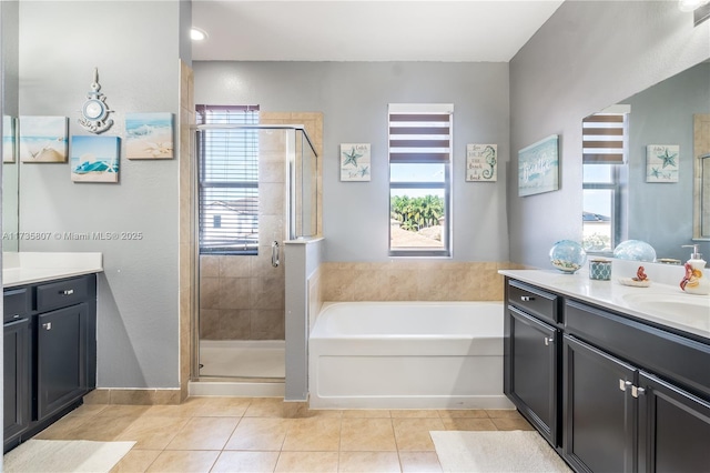 bathroom featuring tile patterned flooring, vanity, and separate shower and tub