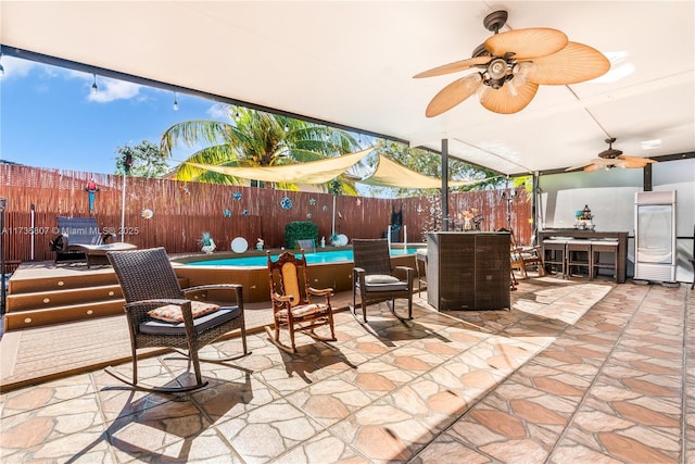 view of patio / terrace featuring a fenced in pool and ceiling fan