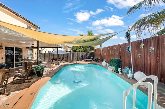 view of swimming pool with a patio area, pool water feature, and ceiling fan