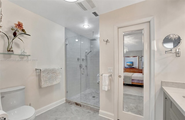 bathroom with vanity, a shower with door, and toilet