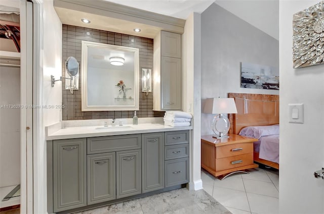 bathroom featuring vanity and decorative backsplash