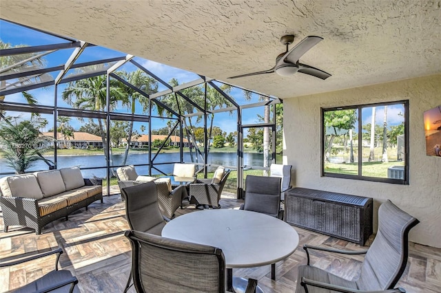 view of patio featuring an outdoor living space, a water view, and glass enclosure