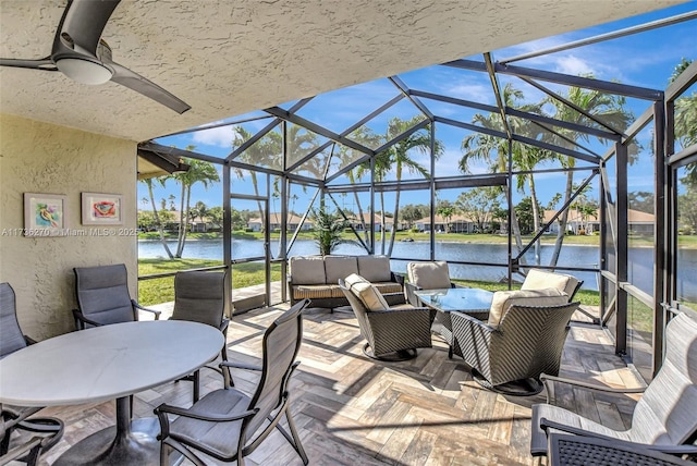 view of patio with a water view, a lanai, and an outdoor hangout area