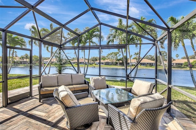 view of patio / terrace with a water view, an outdoor hangout area, and glass enclosure