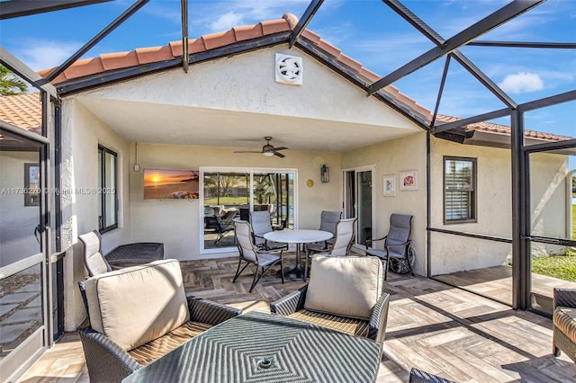 sunroom featuring ceiling fan and lofted ceiling