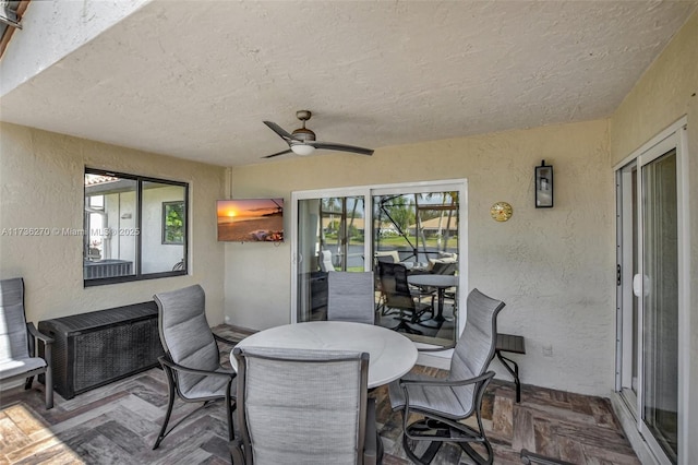 interior space with ceiling fan