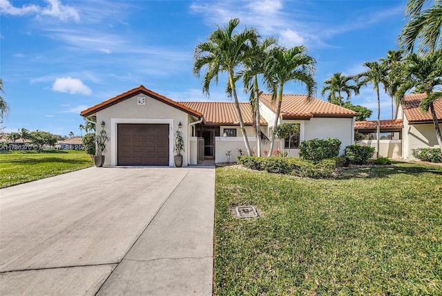 mediterranean / spanish-style home with a garage and a front lawn