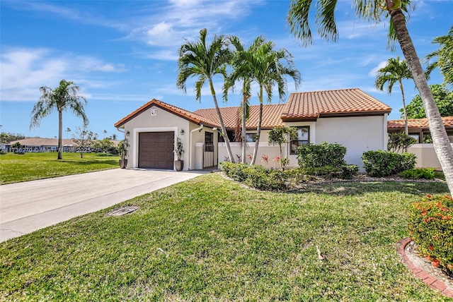 mediterranean / spanish-style house featuring a garage and a front lawn