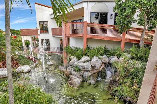 rear view of house with a garden pond