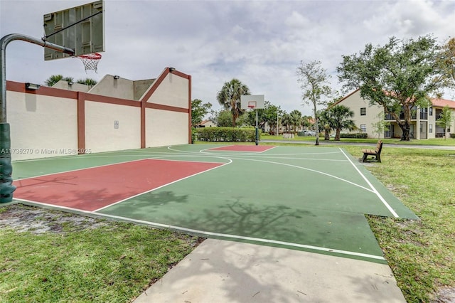 view of basketball court with a yard