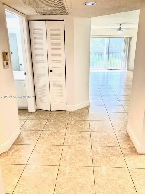 hallway with light tile patterned flooring