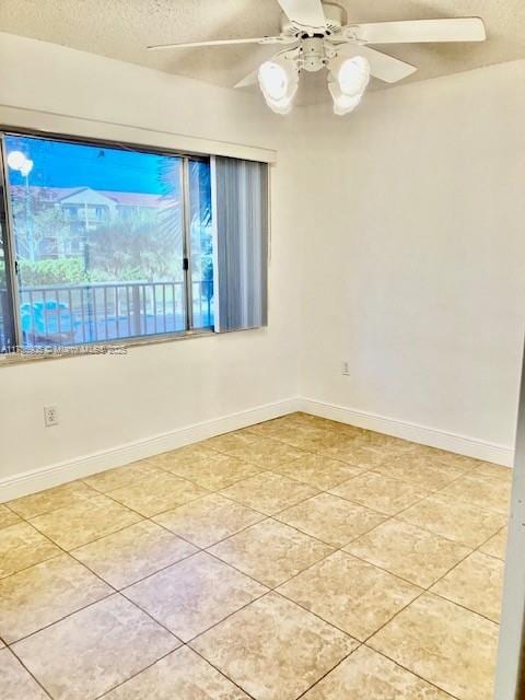 unfurnished room with light tile patterned floors, a textured ceiling, and ceiling fan