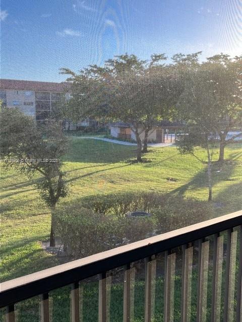 view of yard with a balcony