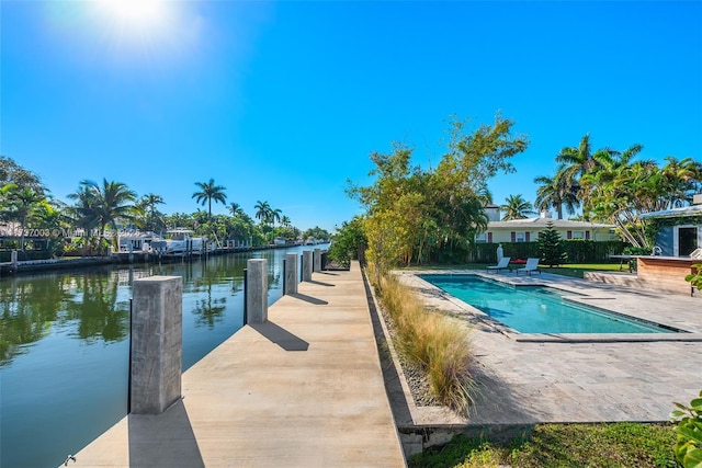 view of swimming pool with a dock and a water view