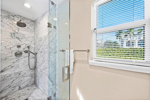 bathroom featuring a shower with shower door