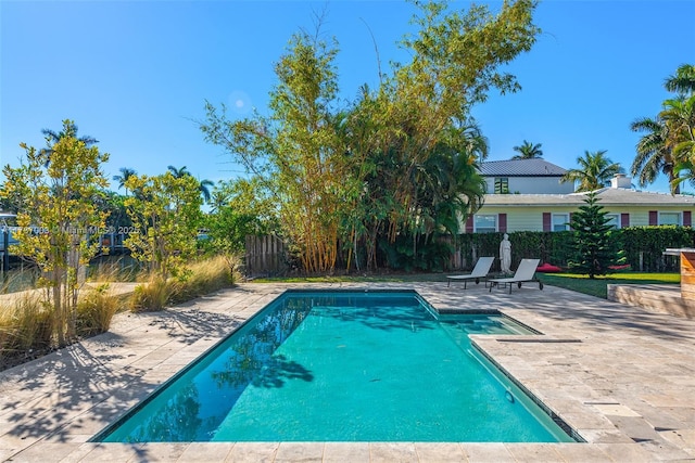 view of swimming pool with a patio