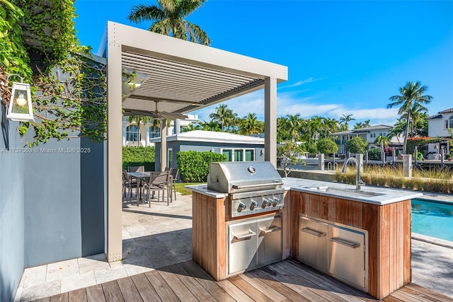 exterior space with a patio, an outdoor kitchen, sink, and grilling area