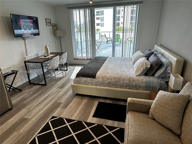 bedroom featuring hardwood / wood-style floors and access to exterior