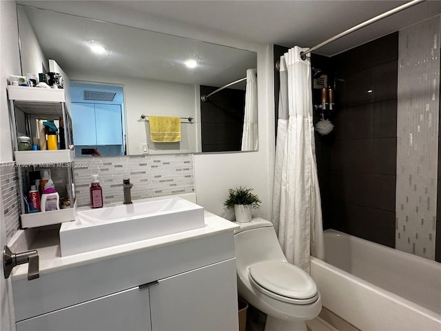 full bathroom featuring vanity, backsplash, toilet, and shower / bath combo with shower curtain