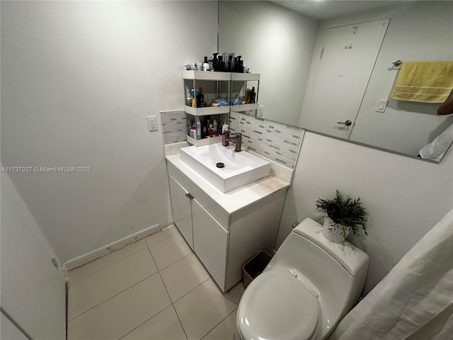 bathroom featuring tile patterned floors, toilet, decorative backsplash, and vanity