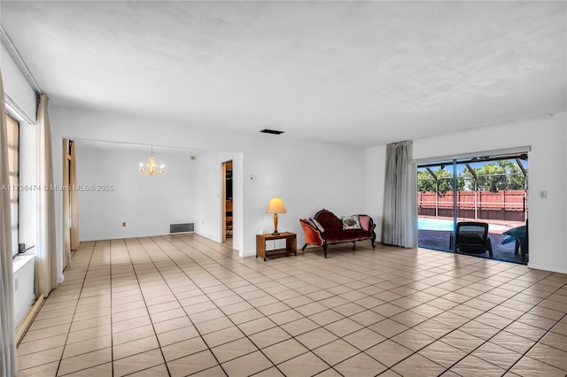 sitting room featuring an inviting chandelier and light tile patterned floors