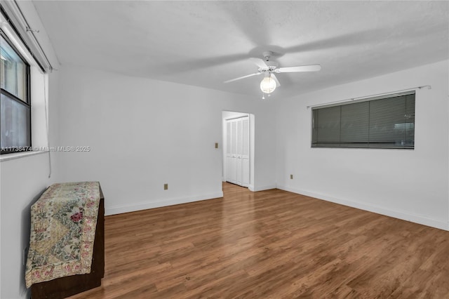 spare room with ceiling fan and hardwood / wood-style floors