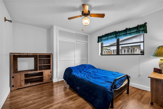 bedroom with ceiling fan and hardwood / wood-style floors