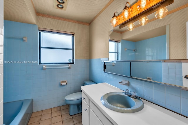 bathroom with crown molding, tile patterned flooring, vanity, toilet, and a bathing tub