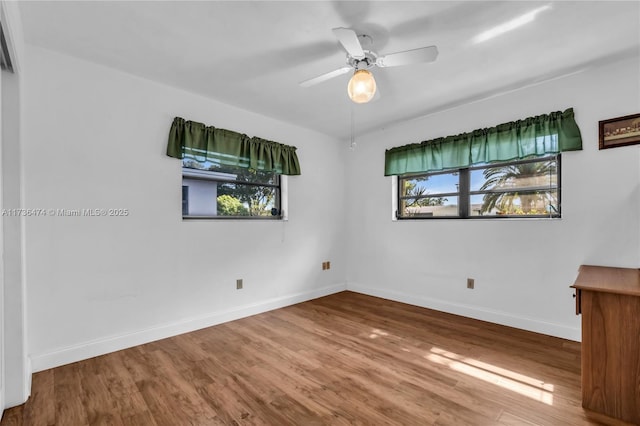 empty room with wood-type flooring and ceiling fan