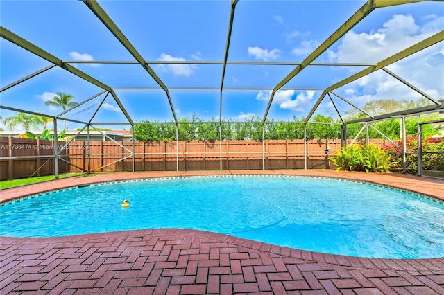 view of pool with a patio and a lanai