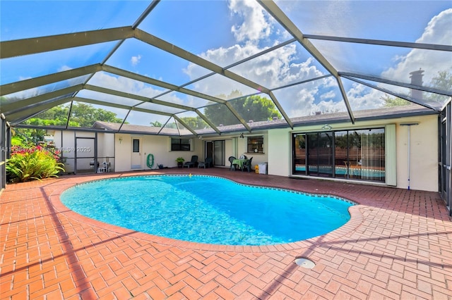 view of pool featuring a patio and glass enclosure