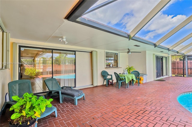 sunroom / solarium with lofted ceiling and ceiling fan