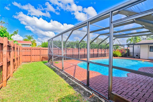 view of swimming pool with a lawn, a patio, and glass enclosure