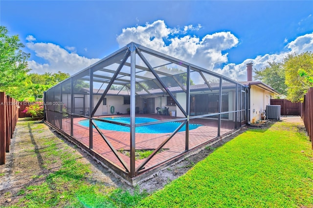 exterior space with a lawn, a lanai, central air condition unit, a fenced in pool, and a patio area