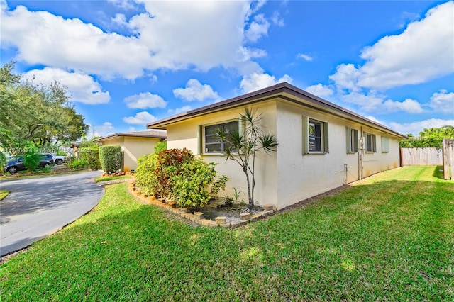 view of property exterior with a yard