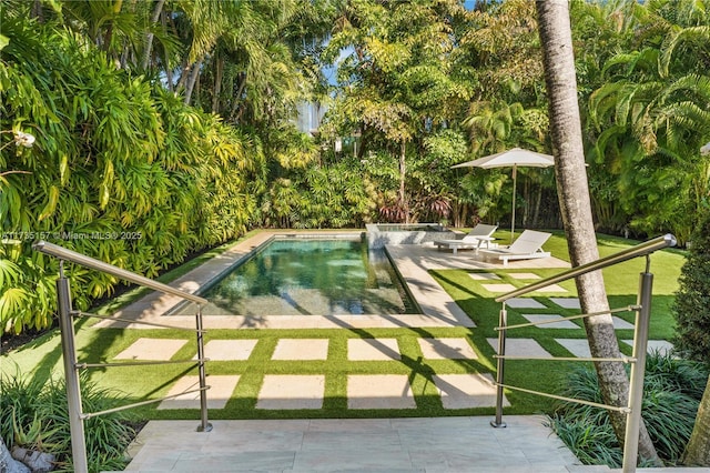 view of swimming pool featuring a yard and a patio area