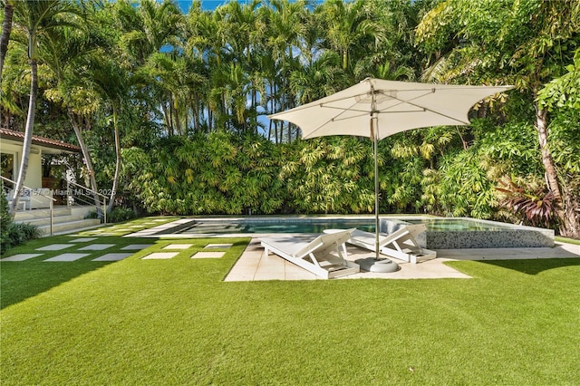 view of swimming pool featuring a yard and a patio